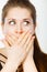 Shocked amazed woman covering mouth with hands