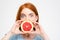 Shocked amusing lady holding grapefruit half in front of mouth