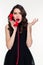 Shocked astonished beautiful retro styled woman talking on red telephone