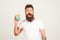 Shocked bearded hipster holding gift box on white background. Surprise emotions man. Black friday shopping, gifts, holiday concept