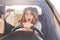 Shocked beautiful European female driver realzes that her car is brocken, can`t repair it by herself, sees awful accident on road,