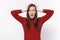 Shocked bewildered young brunette woman girl in casual red clothes posing isolated on white background in studio. People