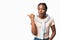 Shocked Black Millennial Woman Pointing Thumb Aside Over White Background