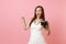 Shocked bride woman in wedding dress pointing index finger holding retro vintage photo camera choosing staff