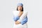 Shocked and concerned young asian girl in sleeping mask and pyjama, hugging pillow and looking tensed as watching