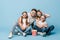 Shocked family in 3d glasses watching movie and holding popcorn bucket