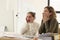 Shocked female managers look at computer monitor at desk