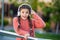Shocked girl taking off headphones for music. Teenager holding headphones next to ears