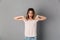 Shocked happy woman in t-shirt pointing and looking down