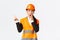 Shocked and impressed asian female engineer, construction manager in safety helmet and reflective jacket, gasping