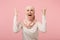 Shocked irritated arabian muslim woman in hijab light clothes posing isolated on pink background. People religious Islam