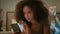 Shocked irritated girl African American young woman gen z user lying on bed with mobile phone at home evening night