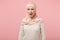 Shocked irritated young arabian muslim woman in hijab light clothes posing isolated on pink background, studio portrait