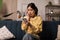 Shocked Japanese Lady Using Mobile Phone Sitting At Home