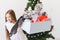 Shocked little child girl looks with opened eyes and worried expression, holding box with various plastic wastes over