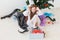 Shocked little child girl looks with opened eyes and worried expression, holding box with various plastic wastes over