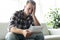 Shocked man holding some documents on sofa livingroom