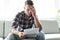 Shocked man holding some documents on sofa livingroom