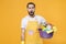 Shocked man househusband in apron rubber gloves hold basin with detergent bottles washing cleansers doing housework