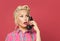 Shocked pinup woman phone. Beautiful retro girl with red lips makeup and old fashion hairstyle
