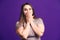 Shocked plus size model on purple background