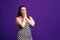 Shocked plus size model on purple background