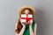 Shocked redhead young woman covering face with present.