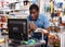 Shocked salesman standing behind counter in household goods store