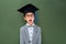 Shocked schoolboy in graduation hat