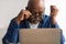 Shocked Senior African Man Looking At Laptop Above Eyeglasses Indoor