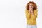Shocked, speechless attractive redhead curly woman in yellow sweater, gasping, shut mouth, press hands to lips, stare