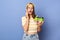 Shocked surprised astonished Caucasian teen girl wearing baseball cap and casual T-shirt standing isolated over blue background,