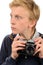 Shocked teenage boy holding retro camera