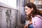 Shocked Woman Looking At Mold On Wall