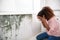 Shocked Woman Looking At Mold On Wall