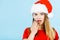 Shocked woman wearing Santa Claus helper costume