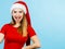 Shocked woman wearing Santa Claus helper costume