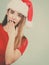 Shocked woman wearing Santa Claus helper costume