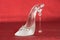 Shoe made of glass on the red background