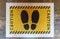 Shoe print stencil on yellow rectangle