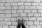 Shoe selfie of man standing on brick patterned flooring in black and white