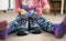 Shoeless child ties shoes - closeup on feet and hands