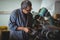 Shoemaker polishing a shoe with machine