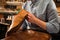 Shoemaker sitting in workshop making shoes