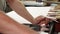 Shoemaker using insole cutting machine at his workshop