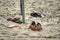 Shoes abandoned on a sandy beach for a walk.