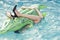 Shoes from crocodile leather. woman on sea with inflatable mattress. female legs hold mattress in swimming pool. Fashion