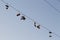 Shoes dangling on a electric cable over the street