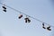 Shoes dangling on a electric cable over the street