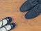 Shoes father and daughter`s shoes on the wooden floor.